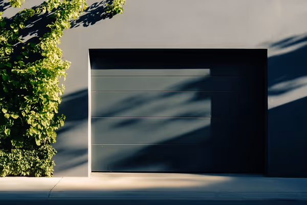 A well-maintained garage door, emphasizing its importance for both aesthetics and security. Styled in a modern suburban setting.